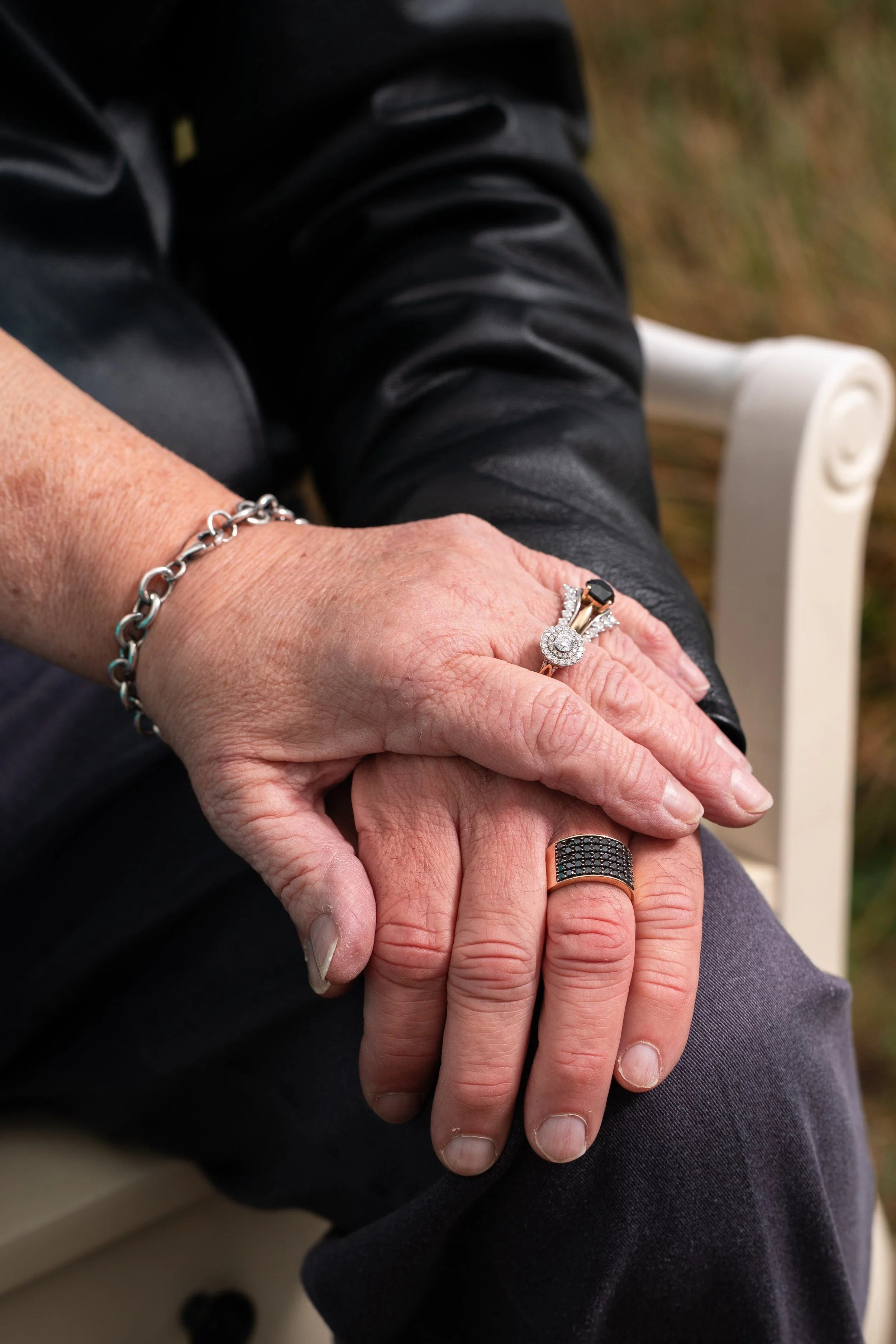 grandparents holding hands on the beach with their family