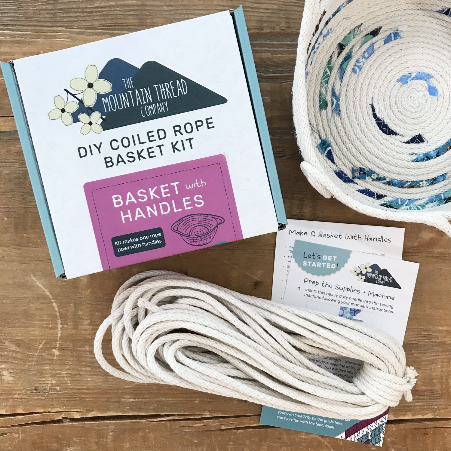 The contents of a Mountain Thread Company Kit on a wooden table