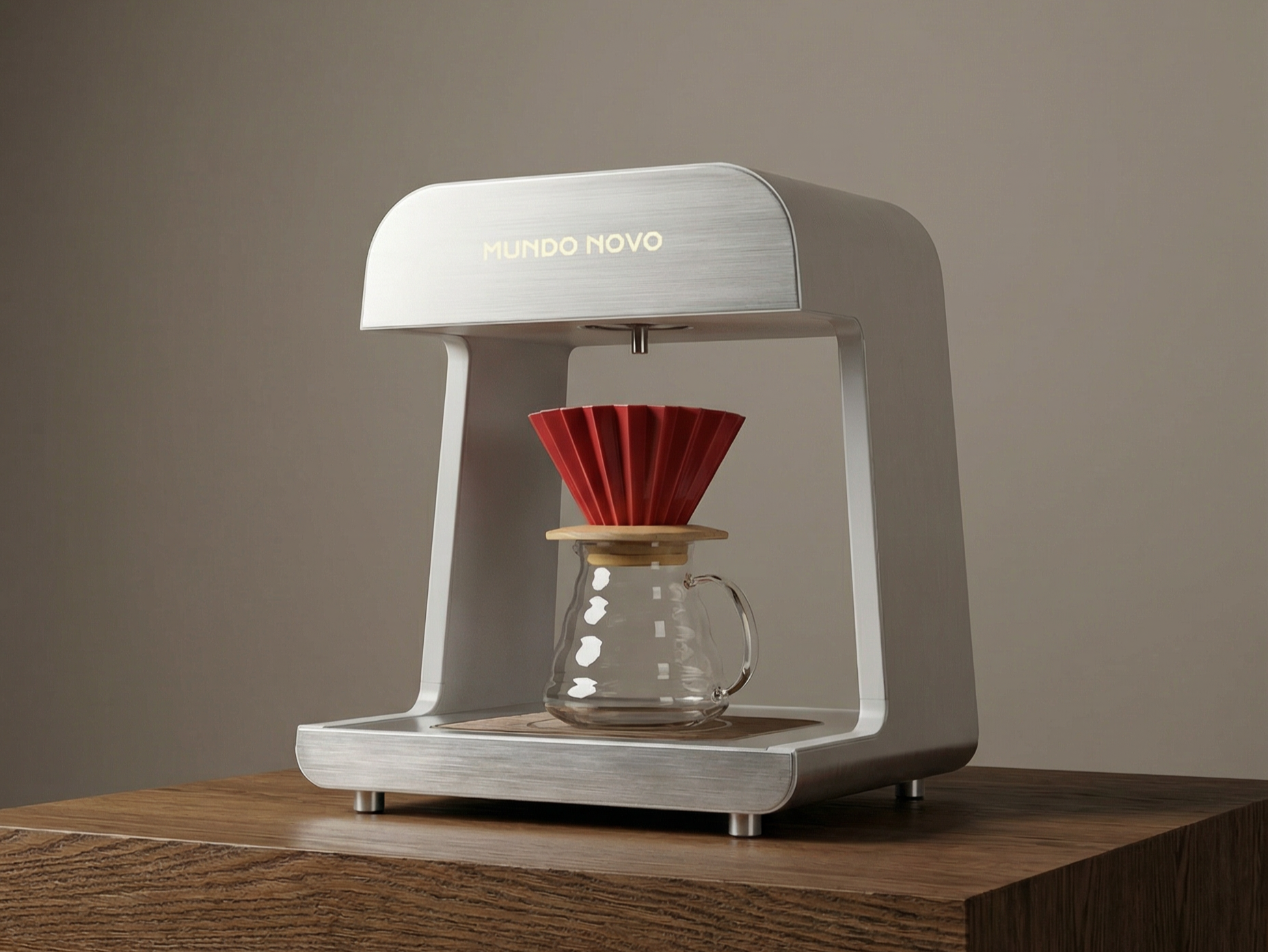 A modern coffee brewing contraption with a glass carafe, a red paper dripper, and a metallic frame with the words "MUNDO NOVO" on the top, set on a wooden table.