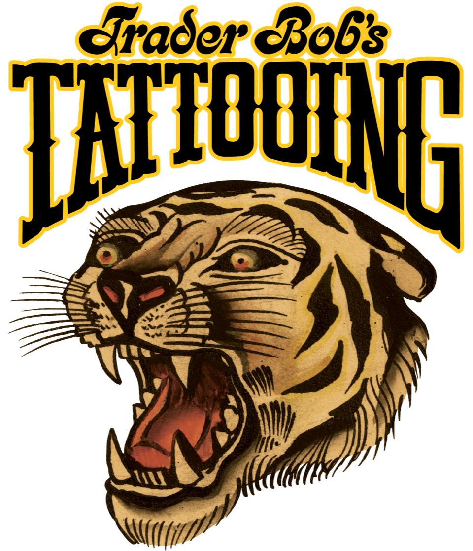 Logo for Trader Bob's Tattooing featuring a fierce, exposed tiger head with yellow eyes and sharp teeth, with bold black and yellow text.