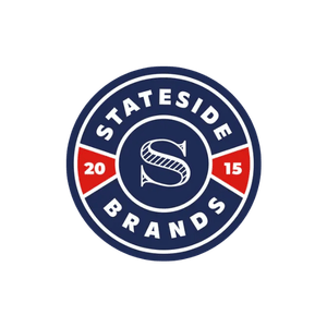 A circular logo for Stateside Brands featuring a navy blue background, a white letter 'S' in the center, and red and white accents with the year 2015.