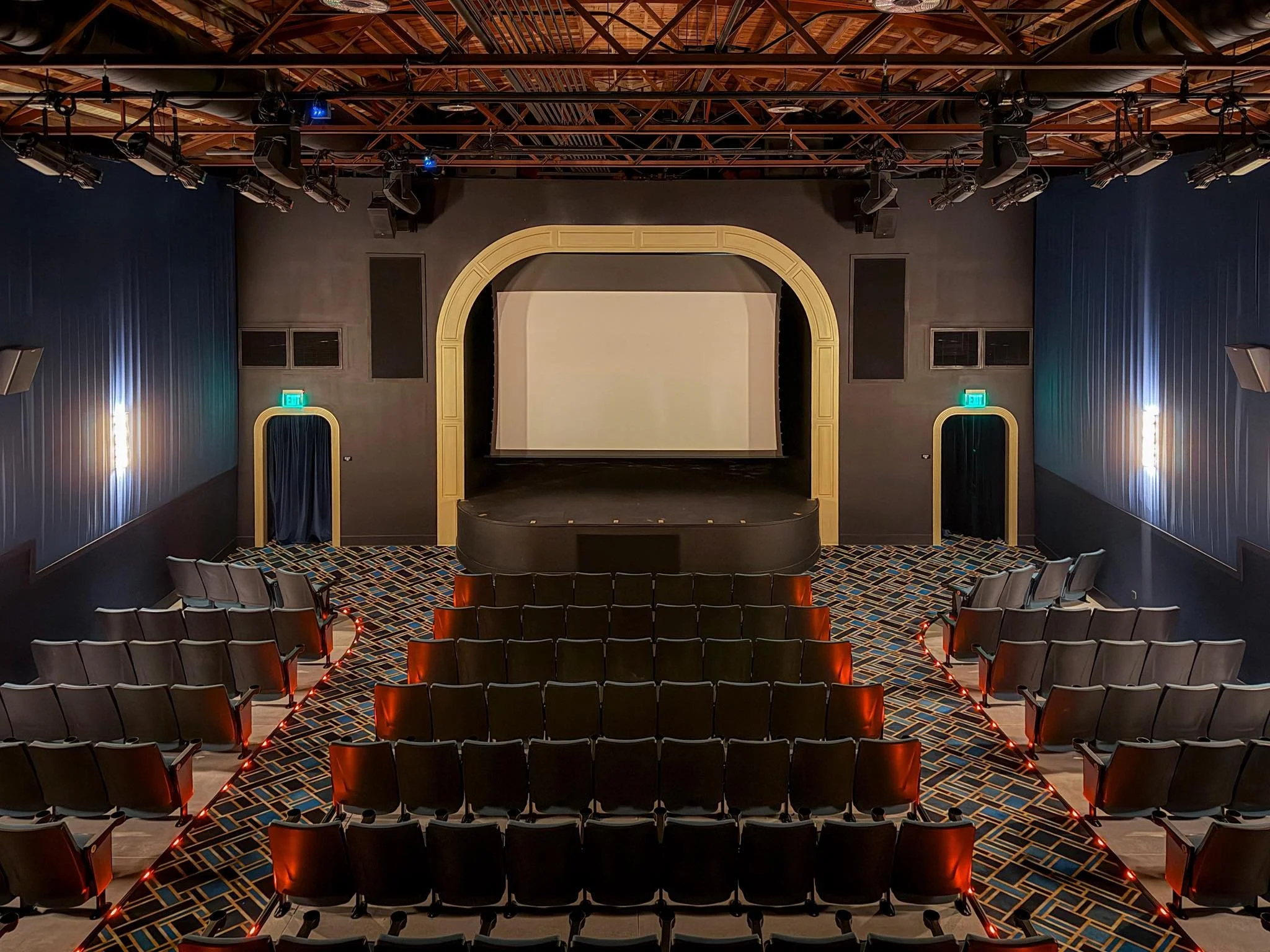 Interior seating and movie screen at The Beach Theatre in St. Pete Beach
