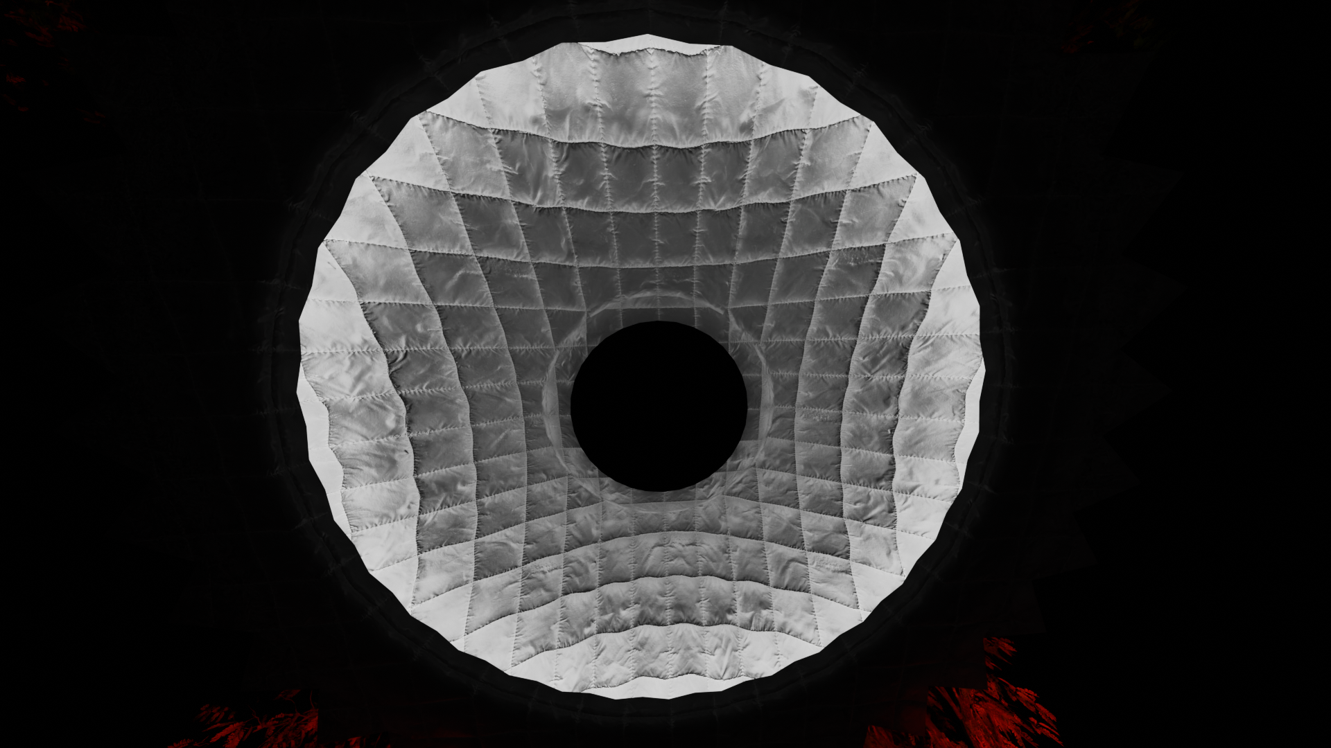 Looking up inside a 10 foot diameter dome with a black circular opening at the top, view shows the fabric panels in shades of gray and the dark interior of the balloon.