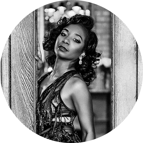 Portrait of an older black woman posing for her boudoir portrait.