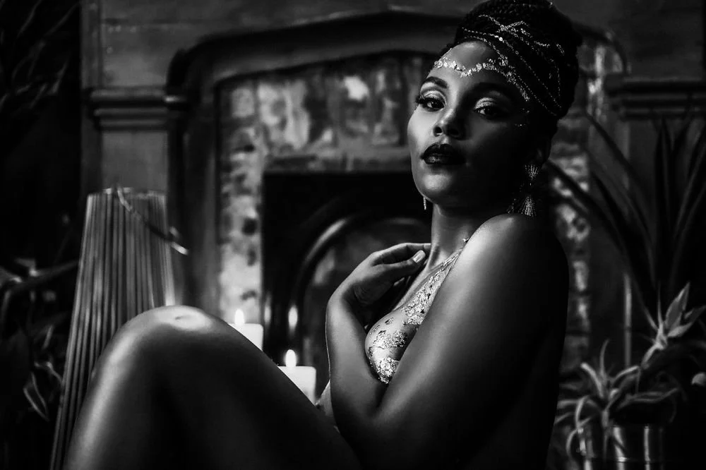 Portrait of  black woman covered in gold foil