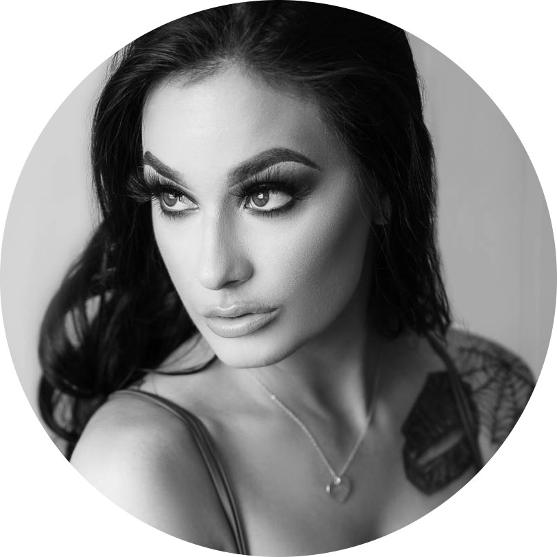 Portrait of a dark haired woman with dramatic eye makeup.