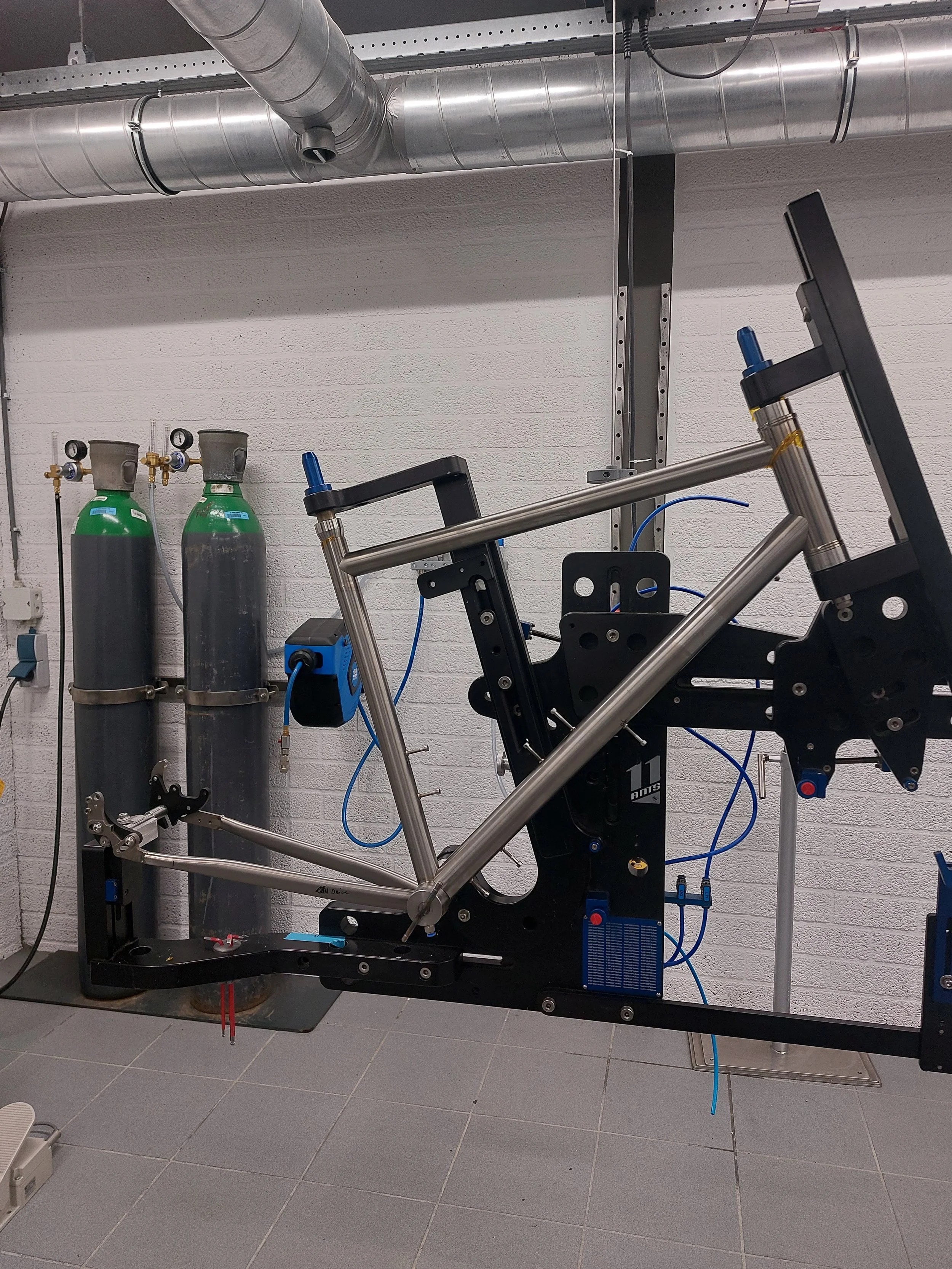 A bicycle frame mounted in a fixture in our workshop