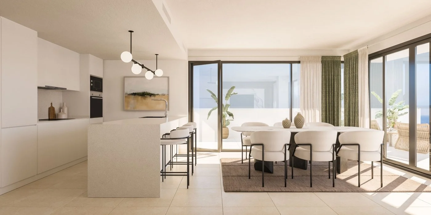 Contemporary open-plan kitchen and dining area with white cabinetry, a kitchen island, bar stools, a large dining table with white chairs, and sliding glass doors leading to a balcony with outdoor seating and potted plants.