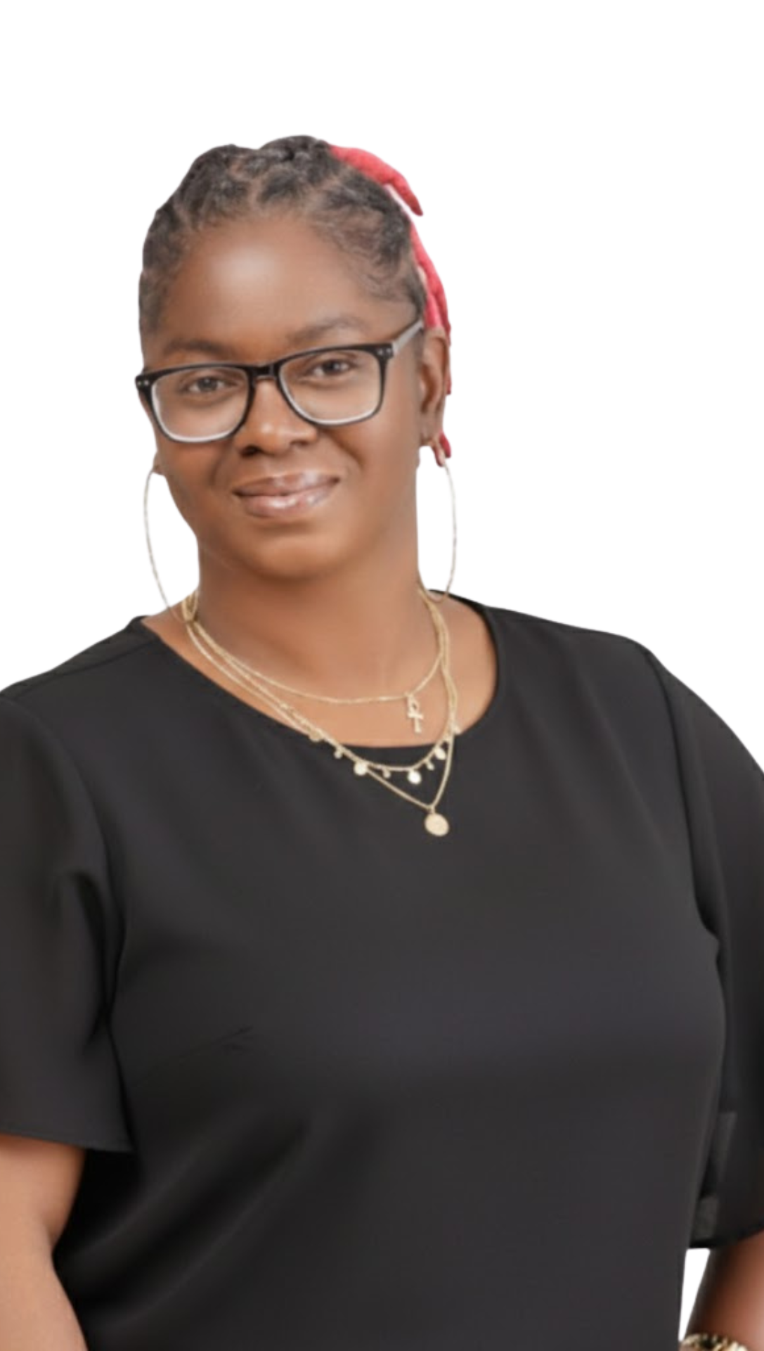 A woman with glasses and box braids wearing a black top and layered gold necklaces.