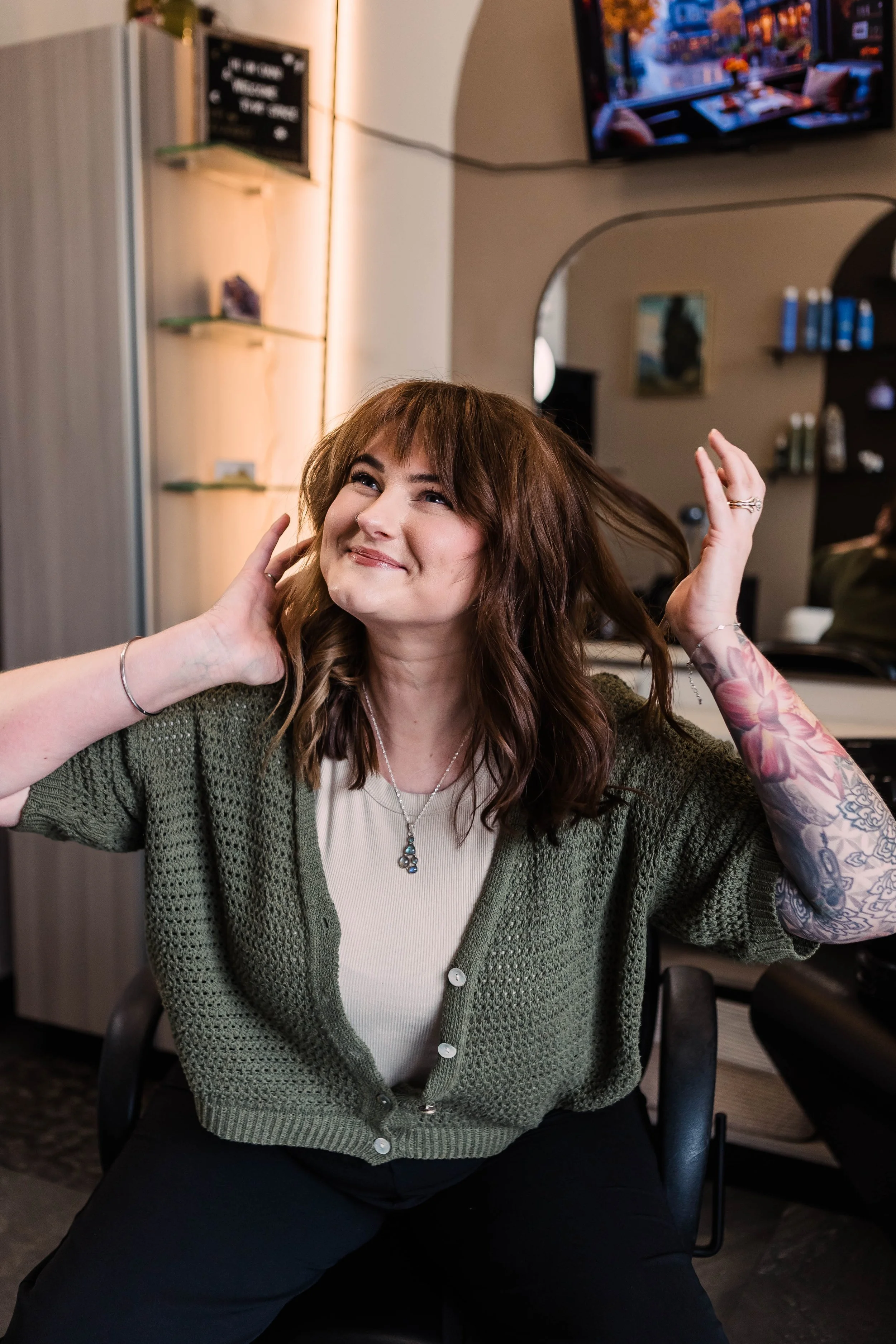 A group of six women standing outside a beauty salon named "blush & bloom", smiling and laughing together.