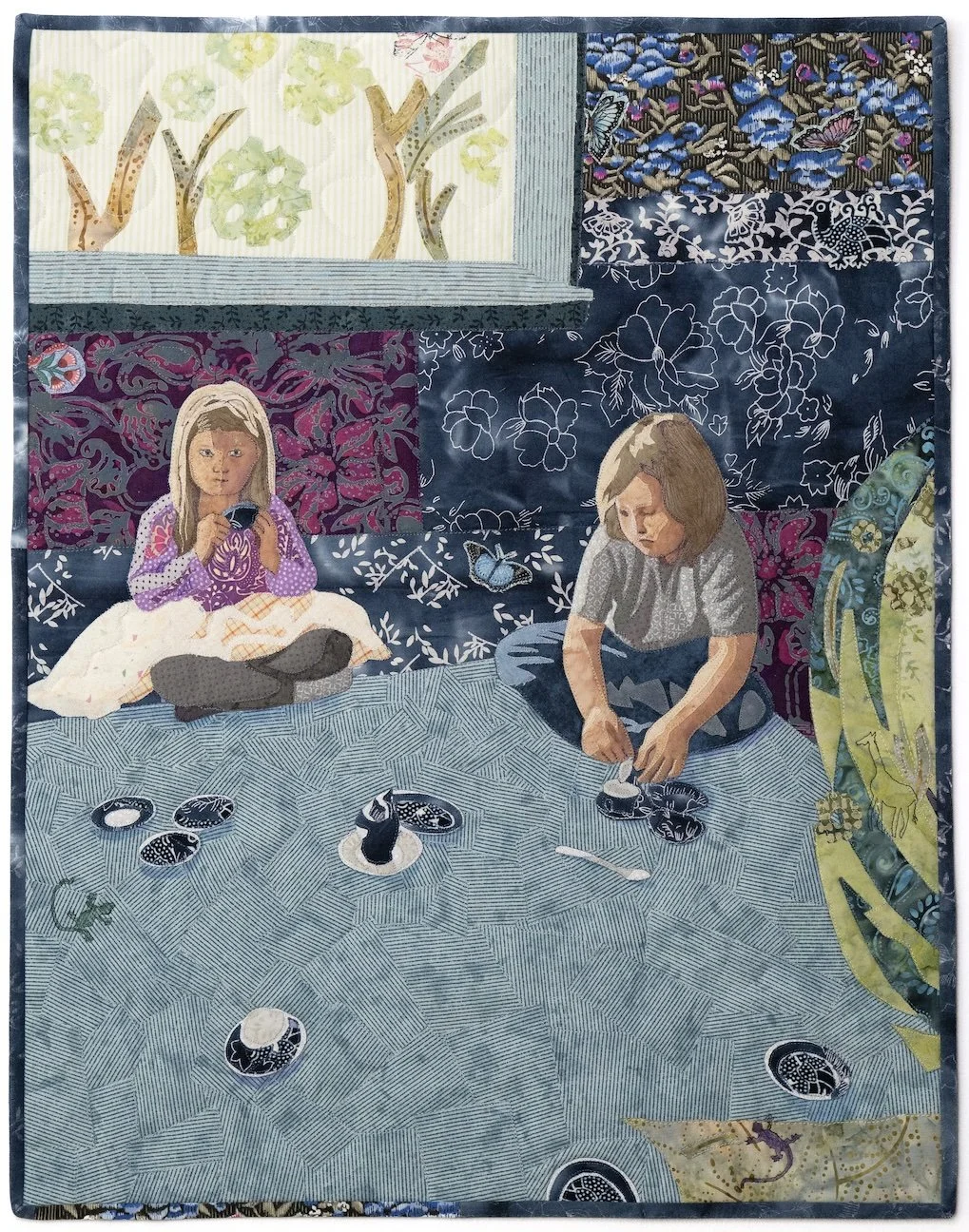 Two children sit on the floor and enjoy a tea party with blue and white small china.