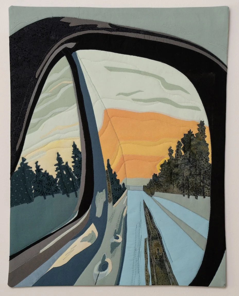We see dusk in a rear view mirror. Trees, snow, road, and sky.