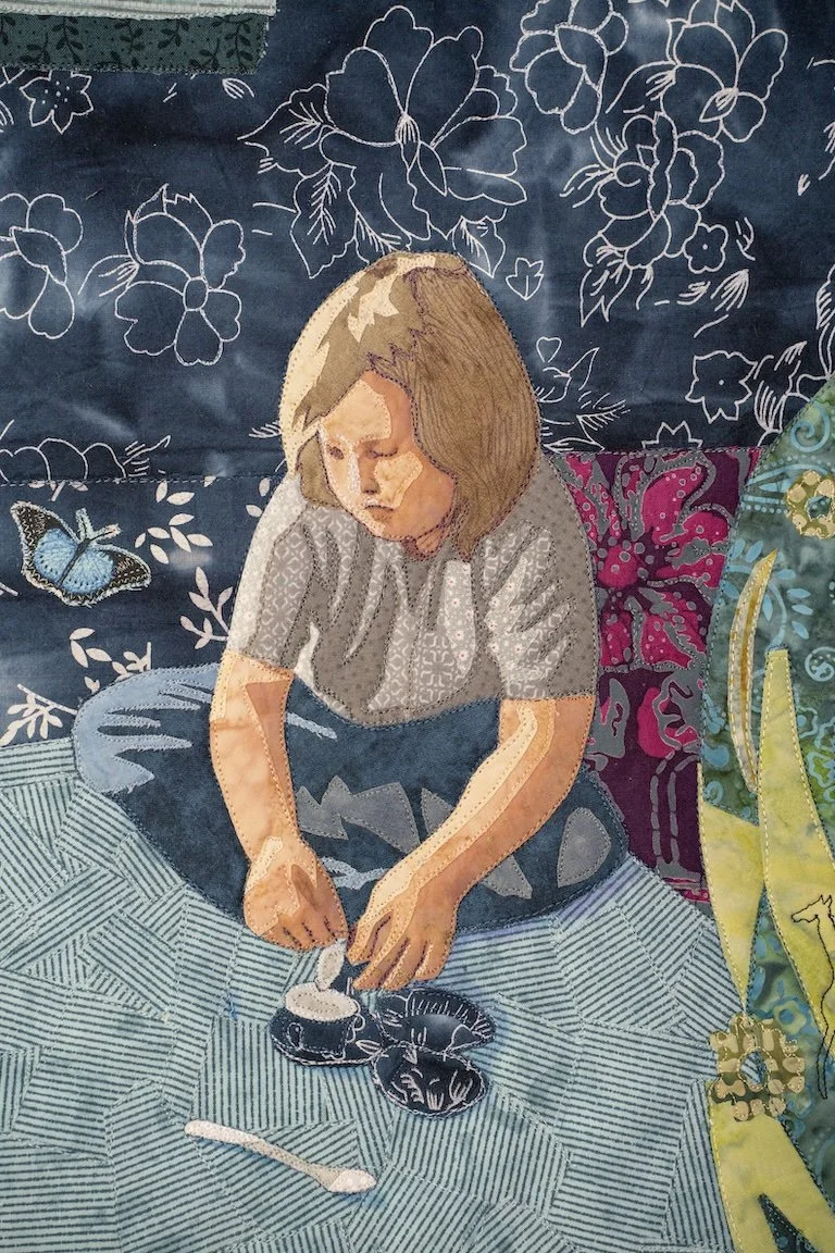 This detail image shows one child pouring cream in a tea cup. There is a blue and white floral background and a multi striped rug.