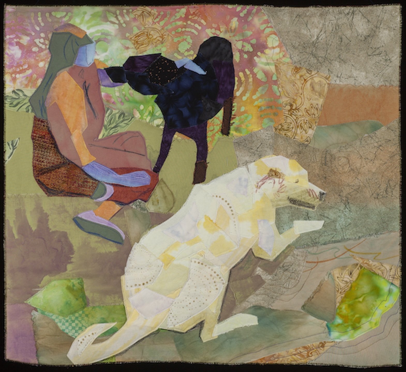 Women petting a black dog, and a white dog relaxing near by.