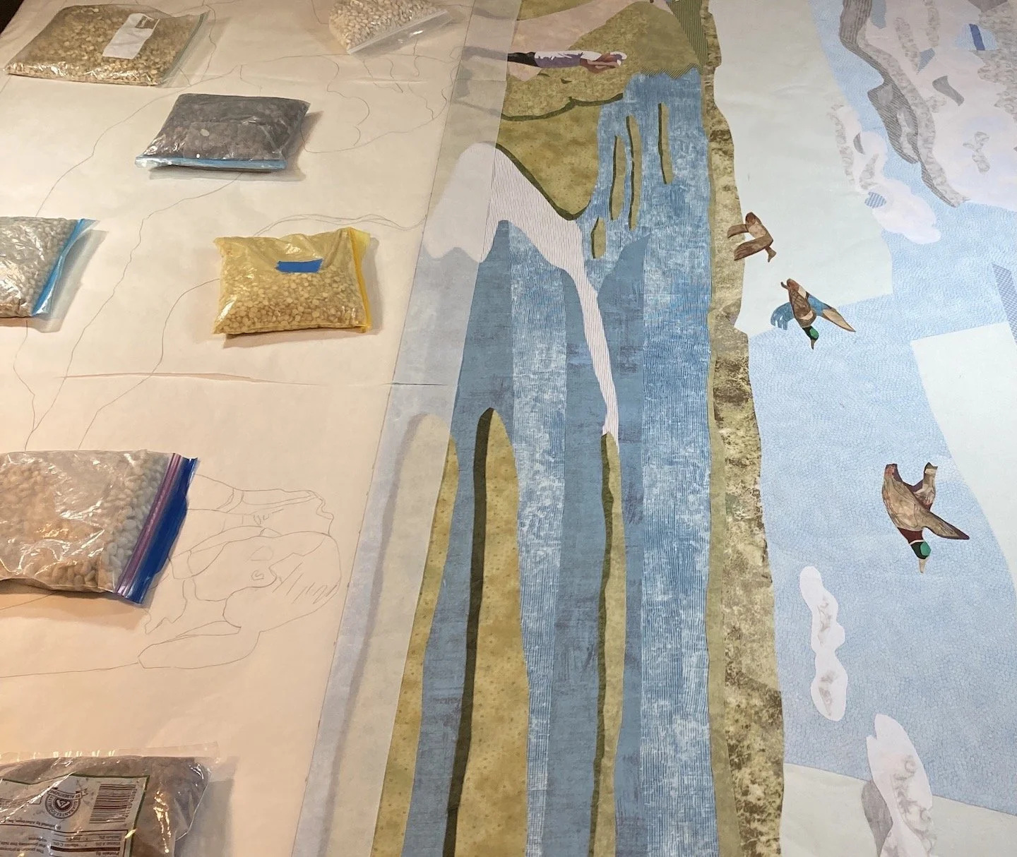 detail of Fusing step, showing bean bags on top of tracing of  placement of fabrics.