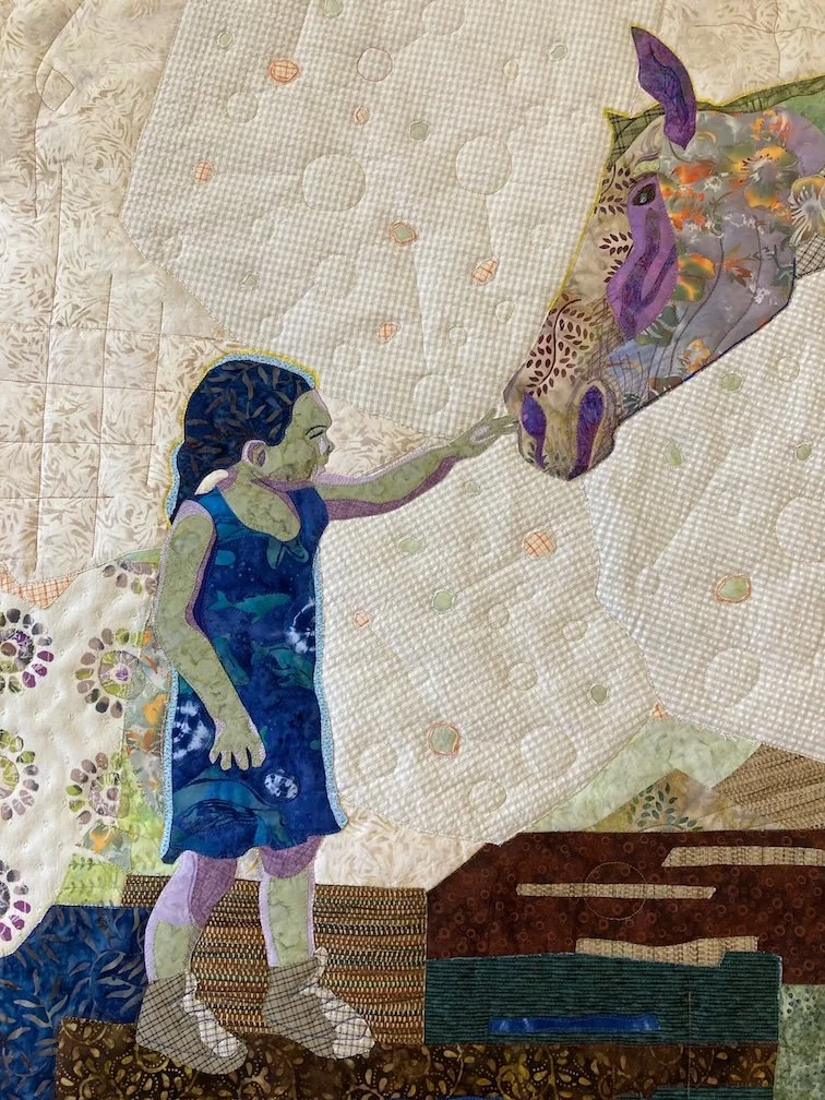 small child touches the nose of a horse