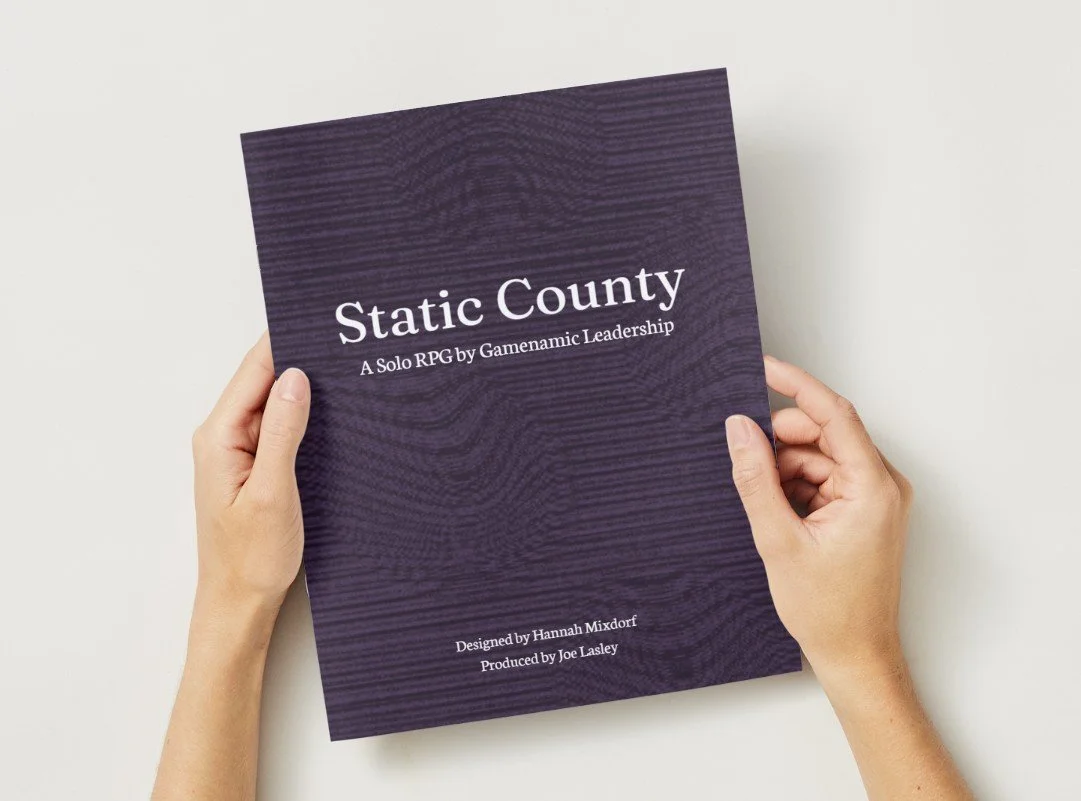 hands holding Static County book