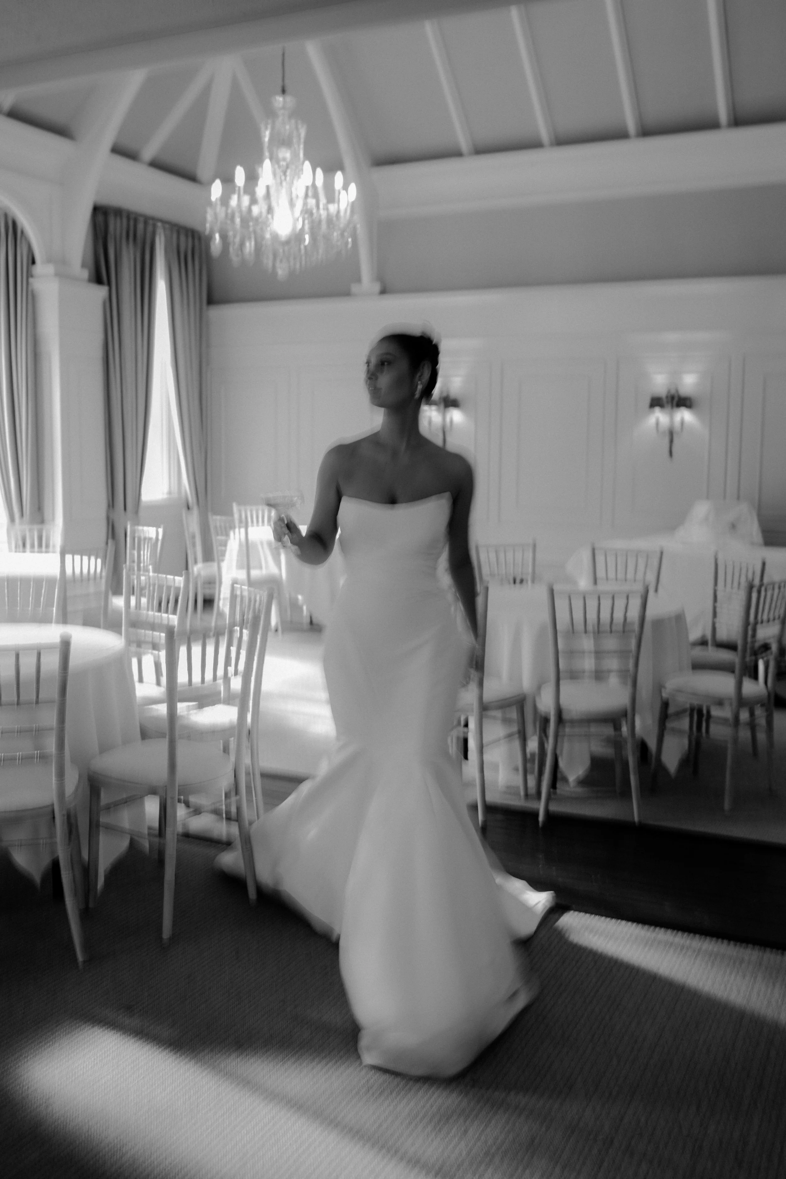 Blurry photo of Bride walking through her wedding breakfast room 