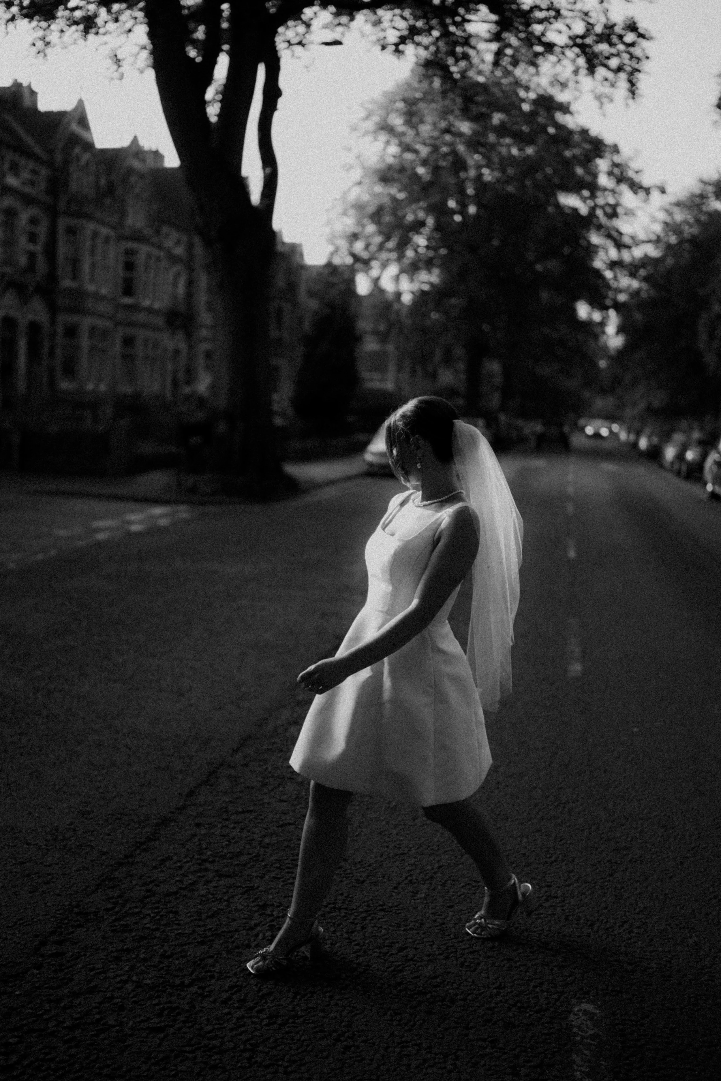 Bride crossing a road on her wedding day