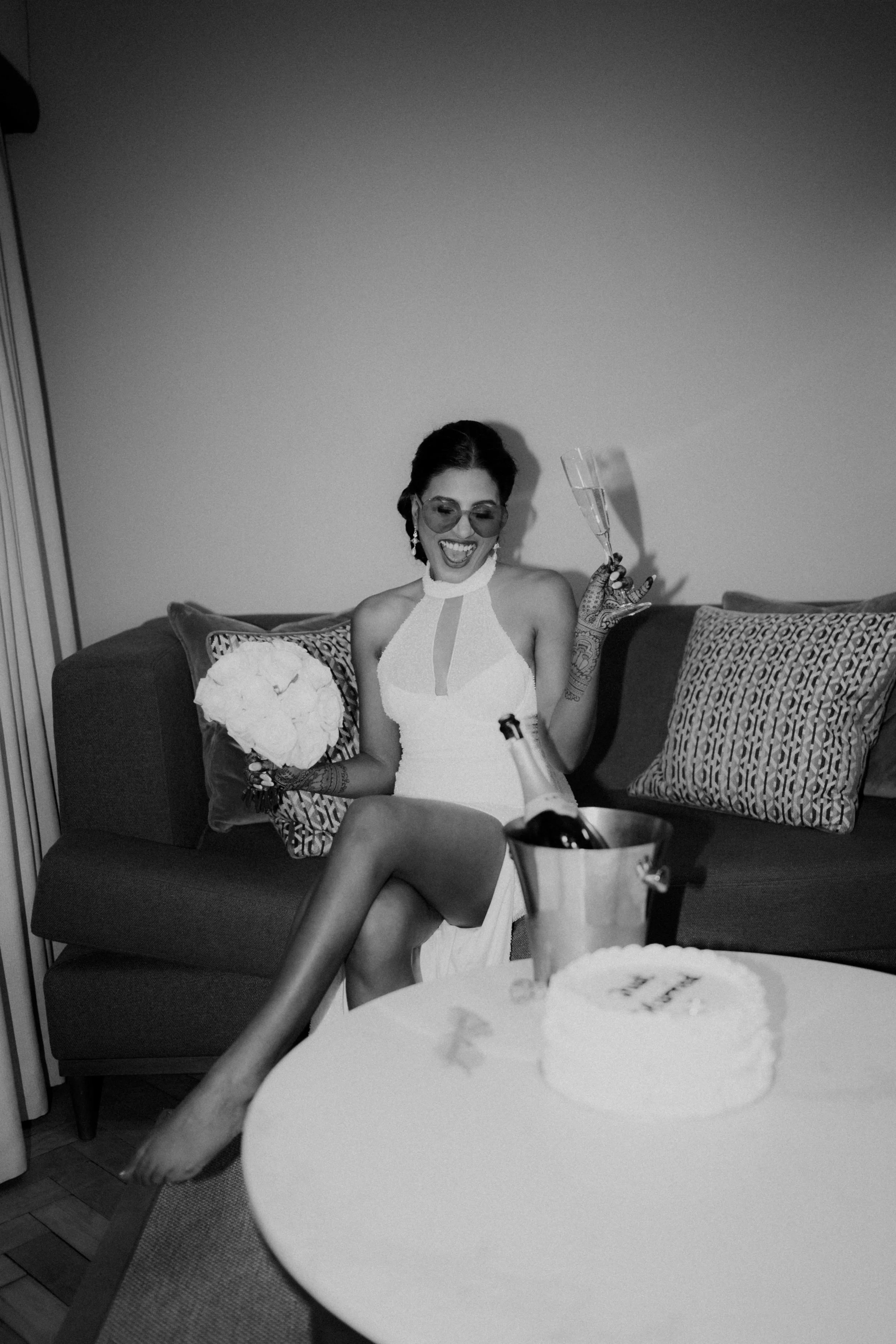 Bride in a bridal suit drinking champagne 
