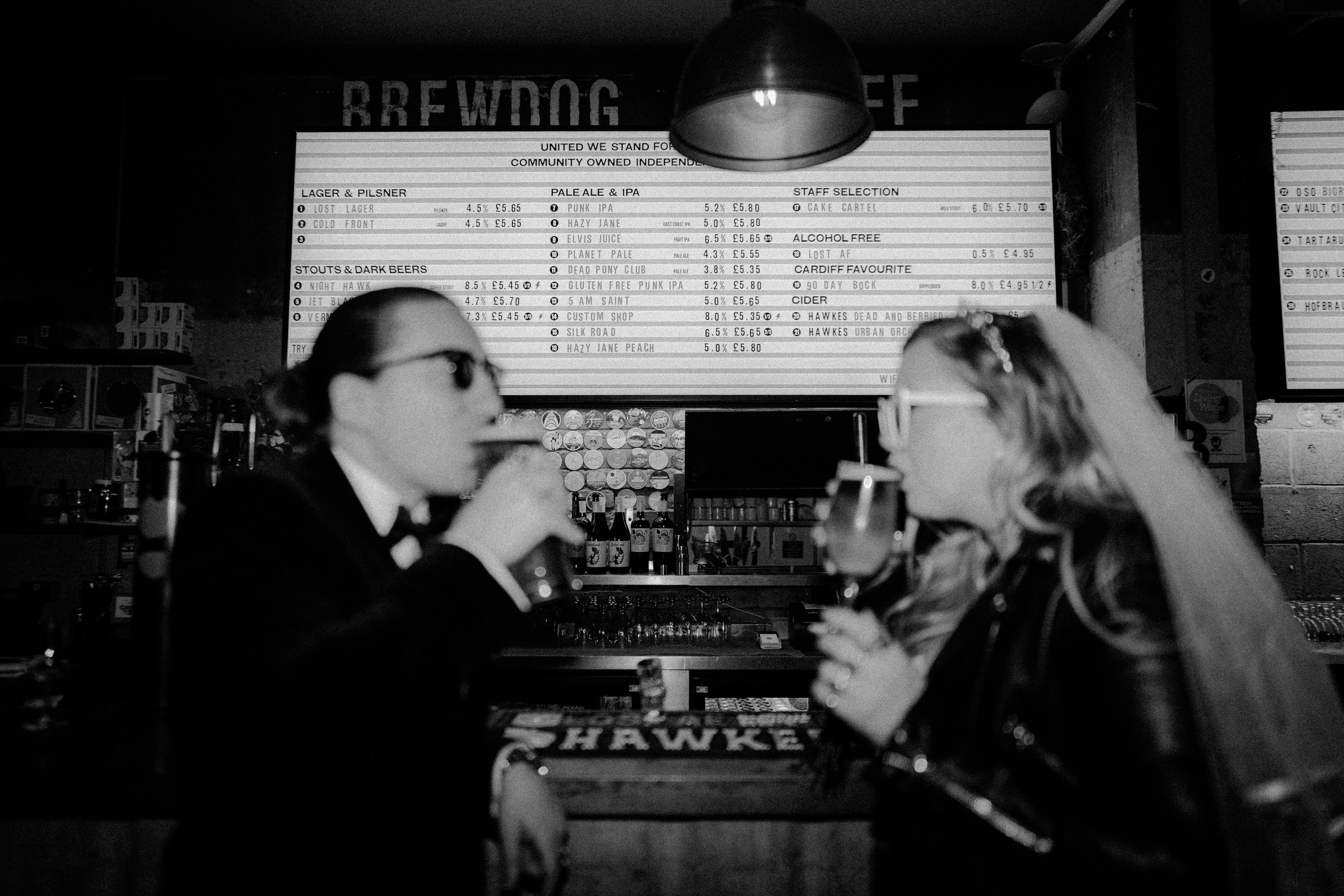 wedding couple drinking at a bar