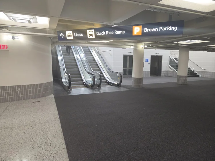 Escalators up to the Brown Ramp limo lobby at MSP Terminal 1
