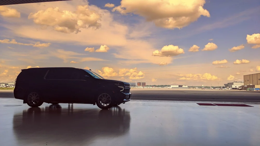 Suburban at a private aviation hangar at sunset for an FBO pickup