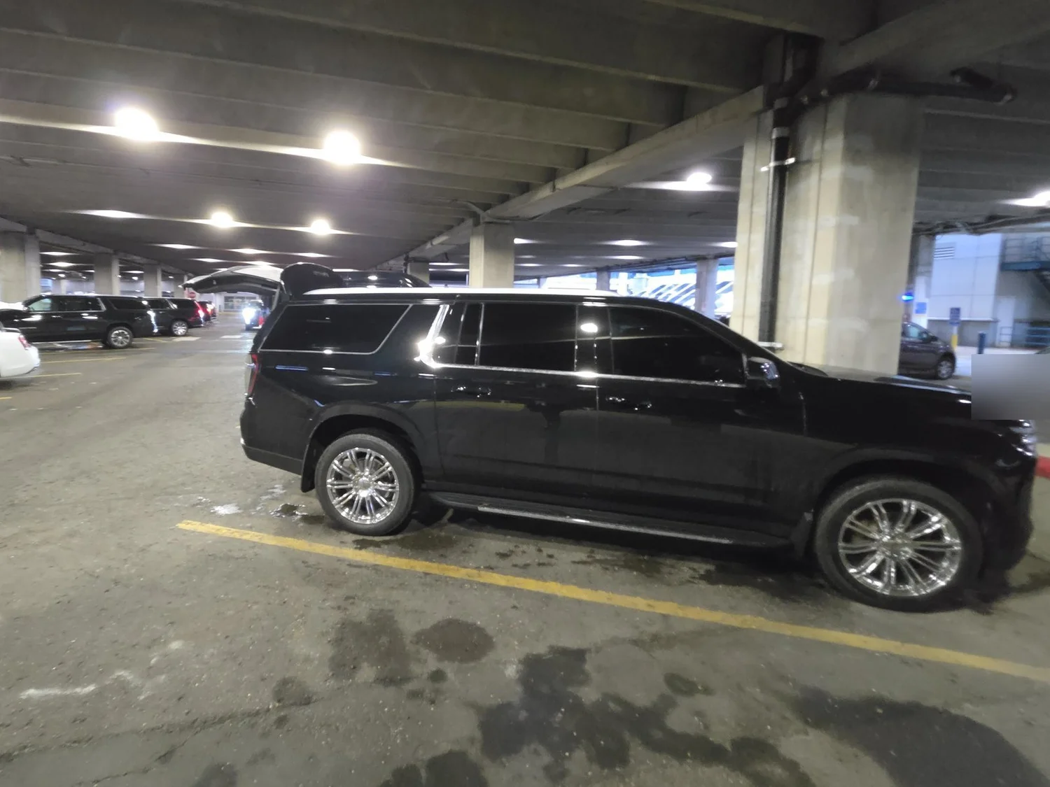 For Sure Luxury Suburban waiting at the MSP Terminal 1 limo pickup area for an arriving client