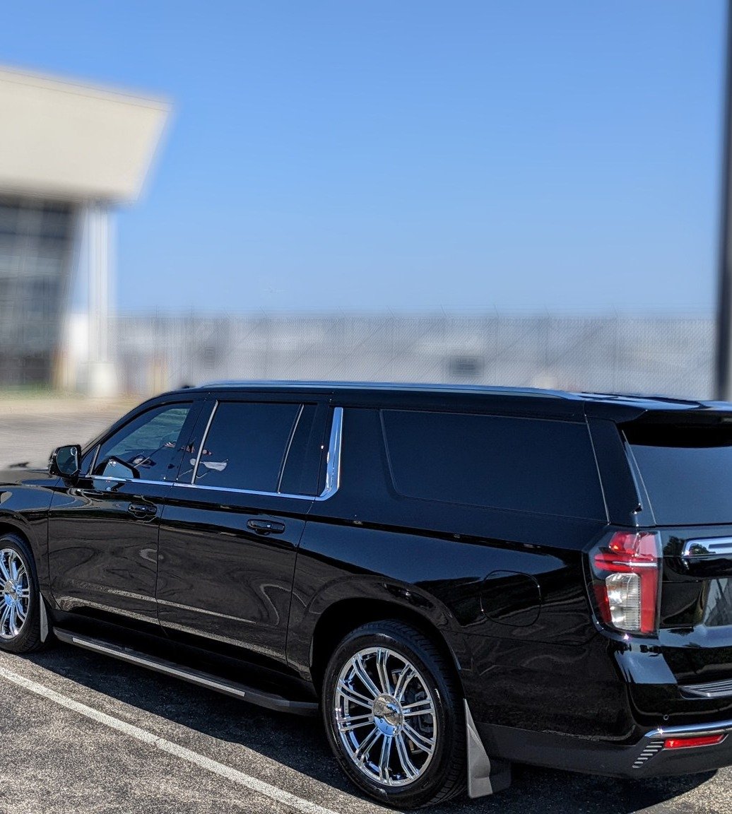 Chauffeured SUV loading luggage for an Apple Valley airport pickup