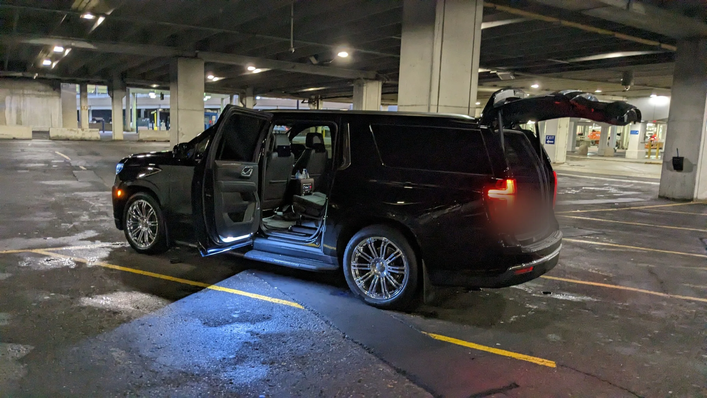For Sure Luxury Suburban with doors open and lit running boards, ready for wedding guests