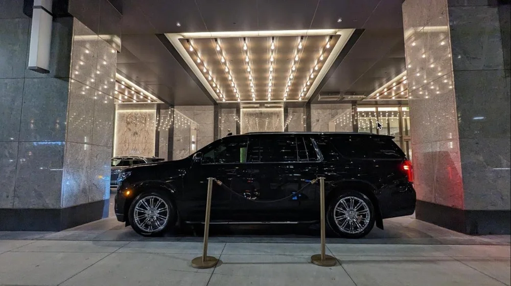 Wedding car waiting under an illuminated hotel canopy