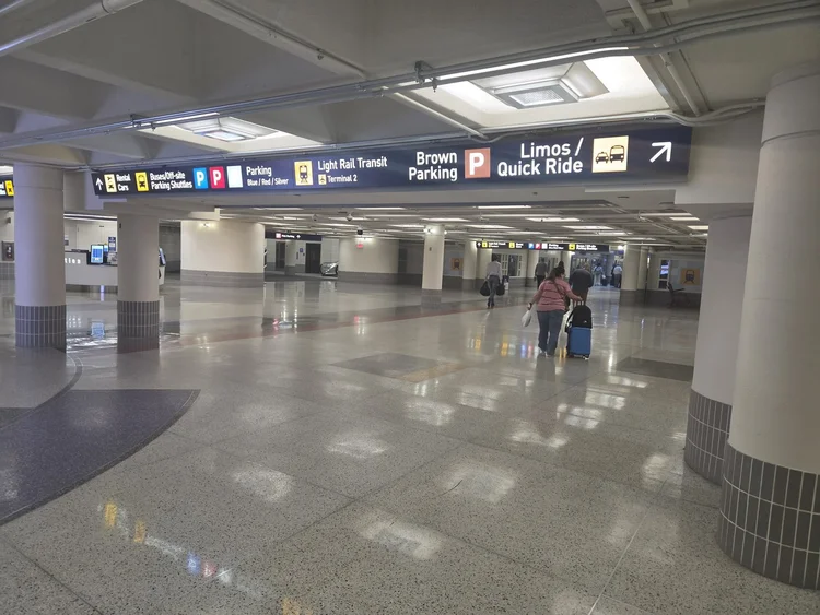 Tunnel walkway with Brown Ramp and Limos signs at MSP Terminal 1