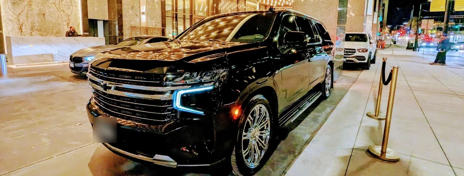 Chauffeured Suburban at a downtown Minneapolis hotel entrance