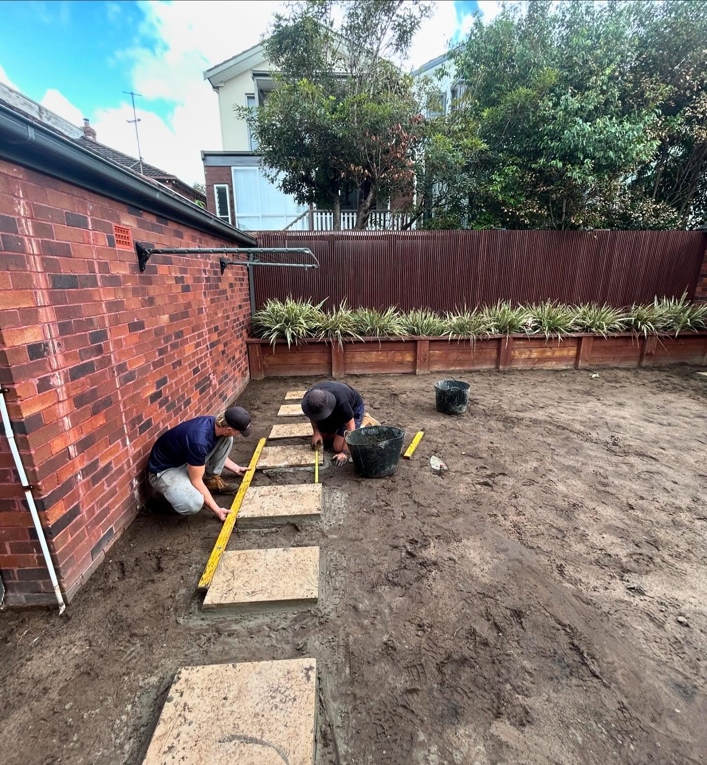 laying outdoor paving stones in a backyard. South Eastern Landscape and Lawn Care Eastern Suburbs Sydney gardeners