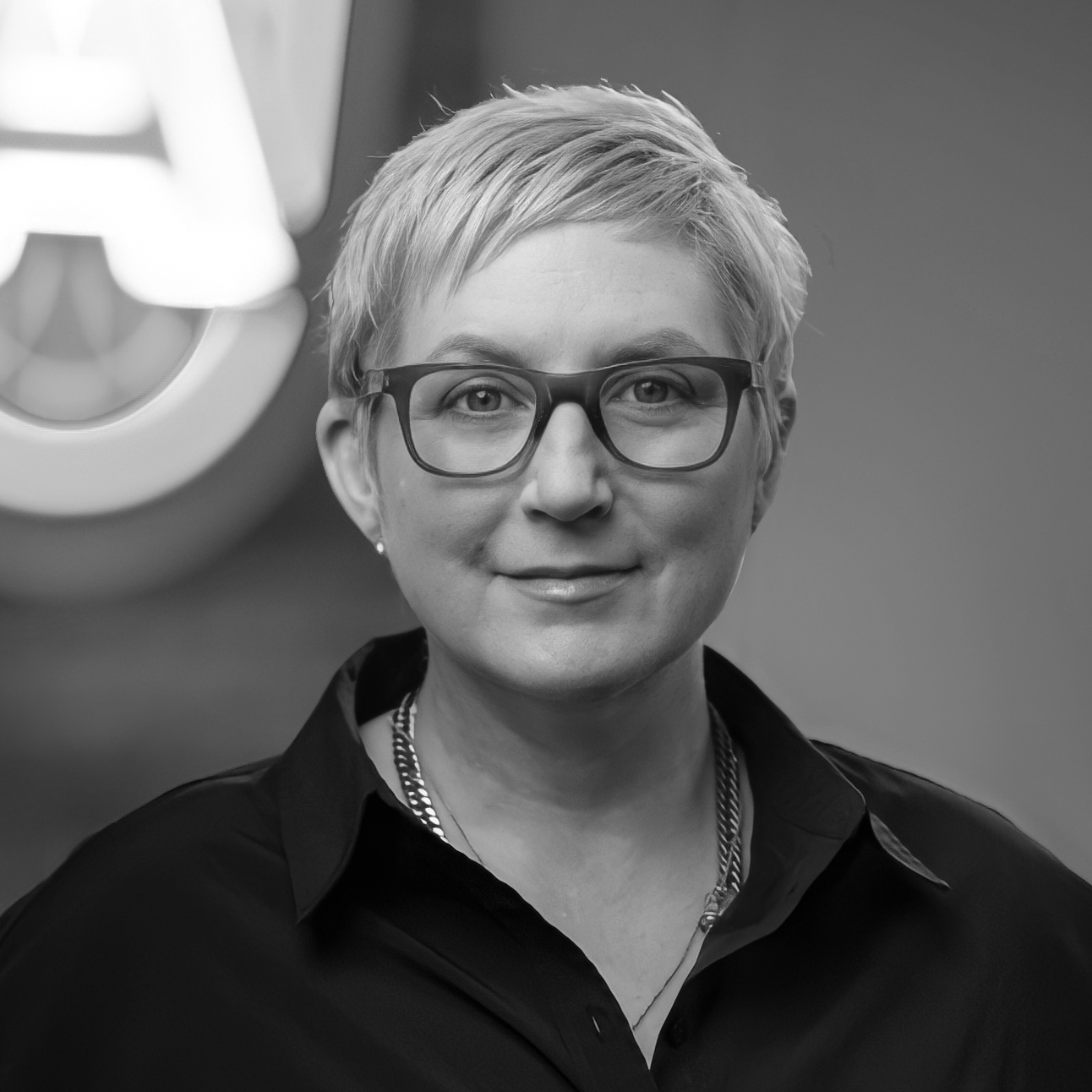Black-and-white portrait of Leslie Mullins, women’s sports brand, product and retail strategist