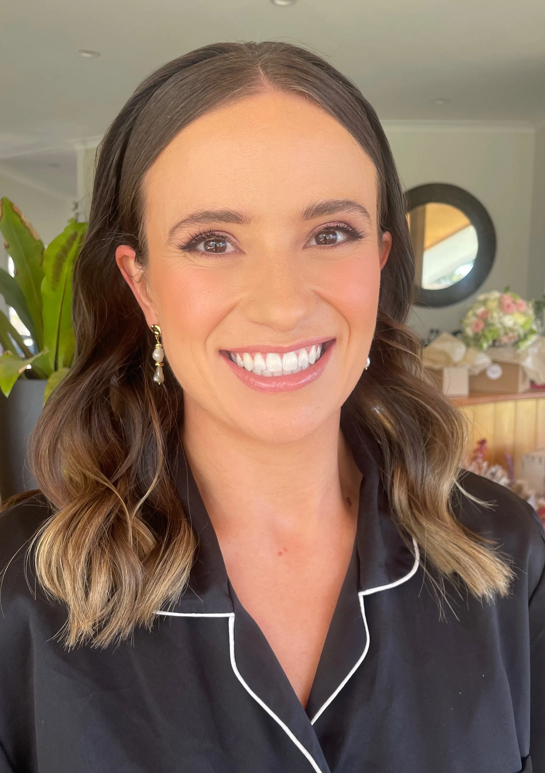 bridesmaid wearing a headband after having makeup professionally applied
