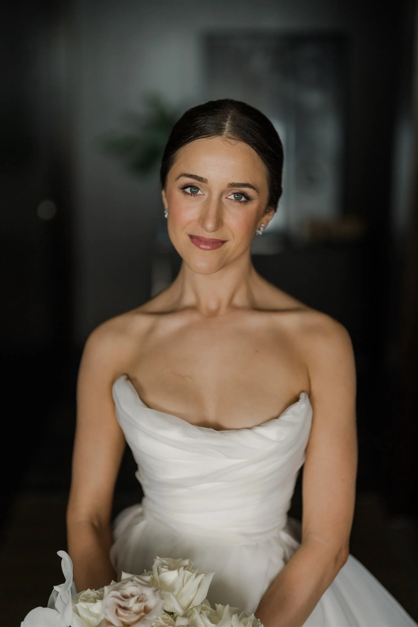 Bride in soft focus looking at the camera.