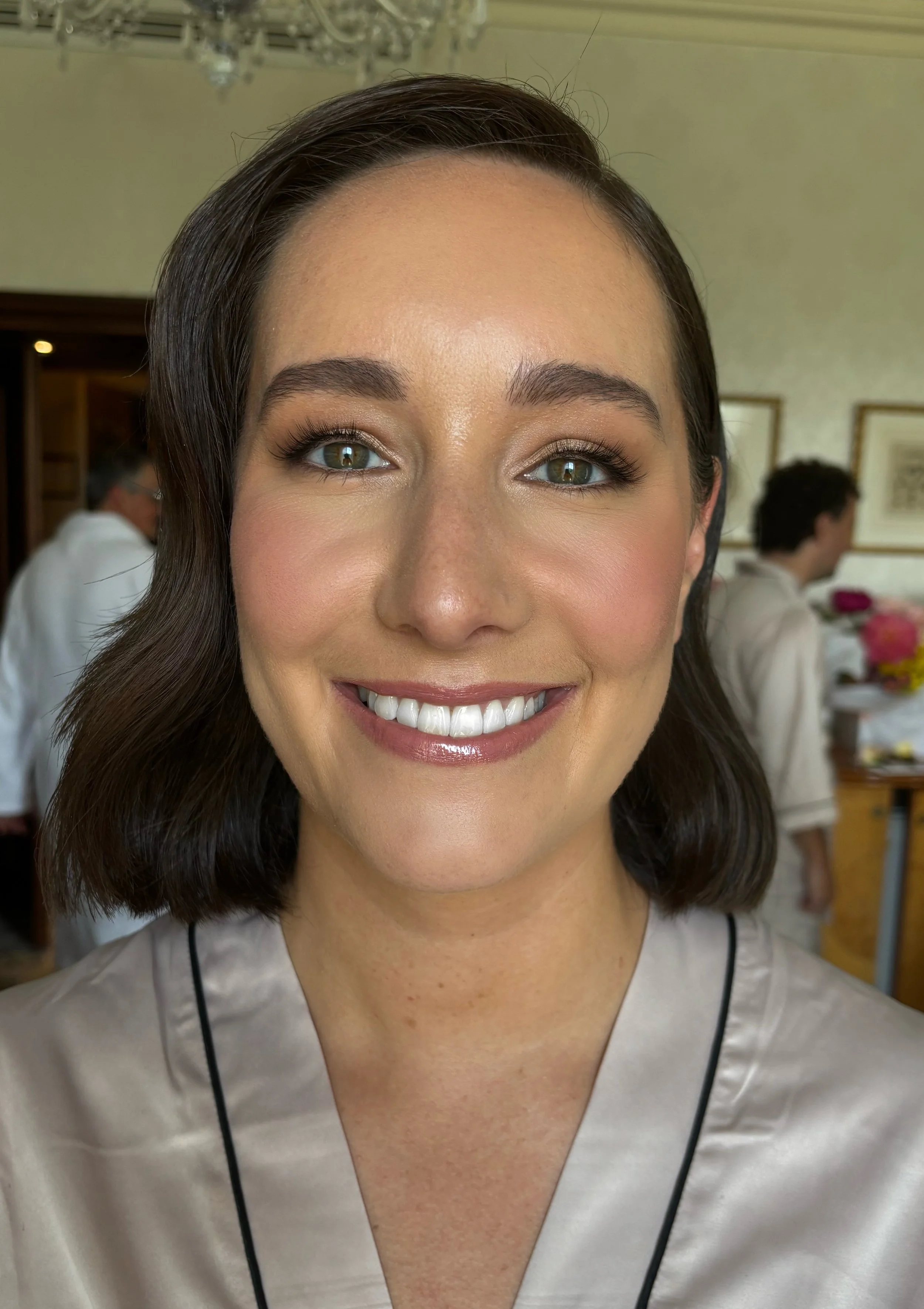 smiling bride after having her makeup applied by a professional makeup artist in geelong