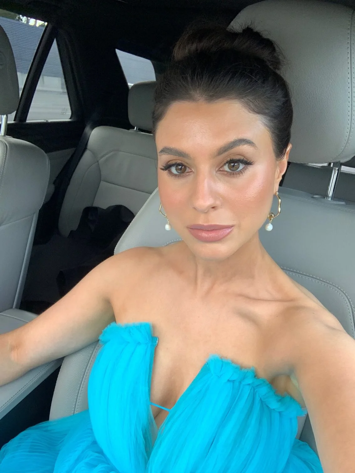 Ready for a day at the Spring racing carnival, this woman wearing a striking blue dress and makeup professionally applied by Jessica O'Donnell