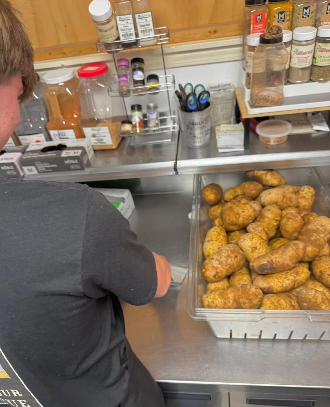 The other side of the service line? 
Beau washing &amp; sorting through taters for Loaded Potatoes 🥔 
Sunday only 
11-3
*while supplies last 
$13- pulled pork, $16 brisket
Butter, sour cream shredded cheese