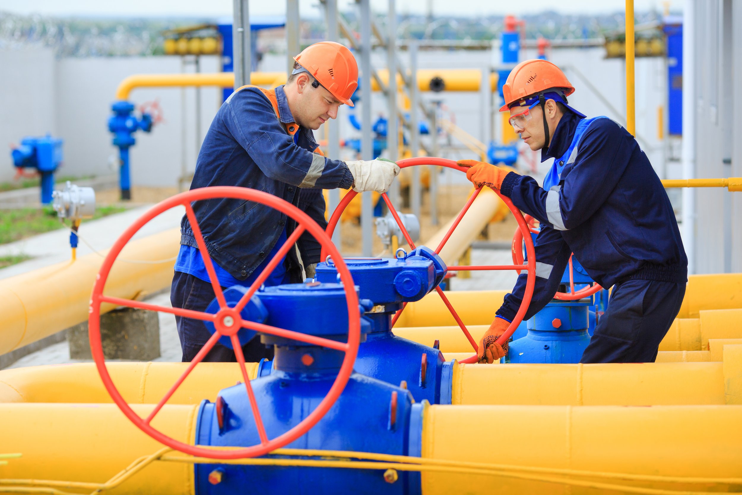 uniformed-worker-opens-valve-control-gases.jpg