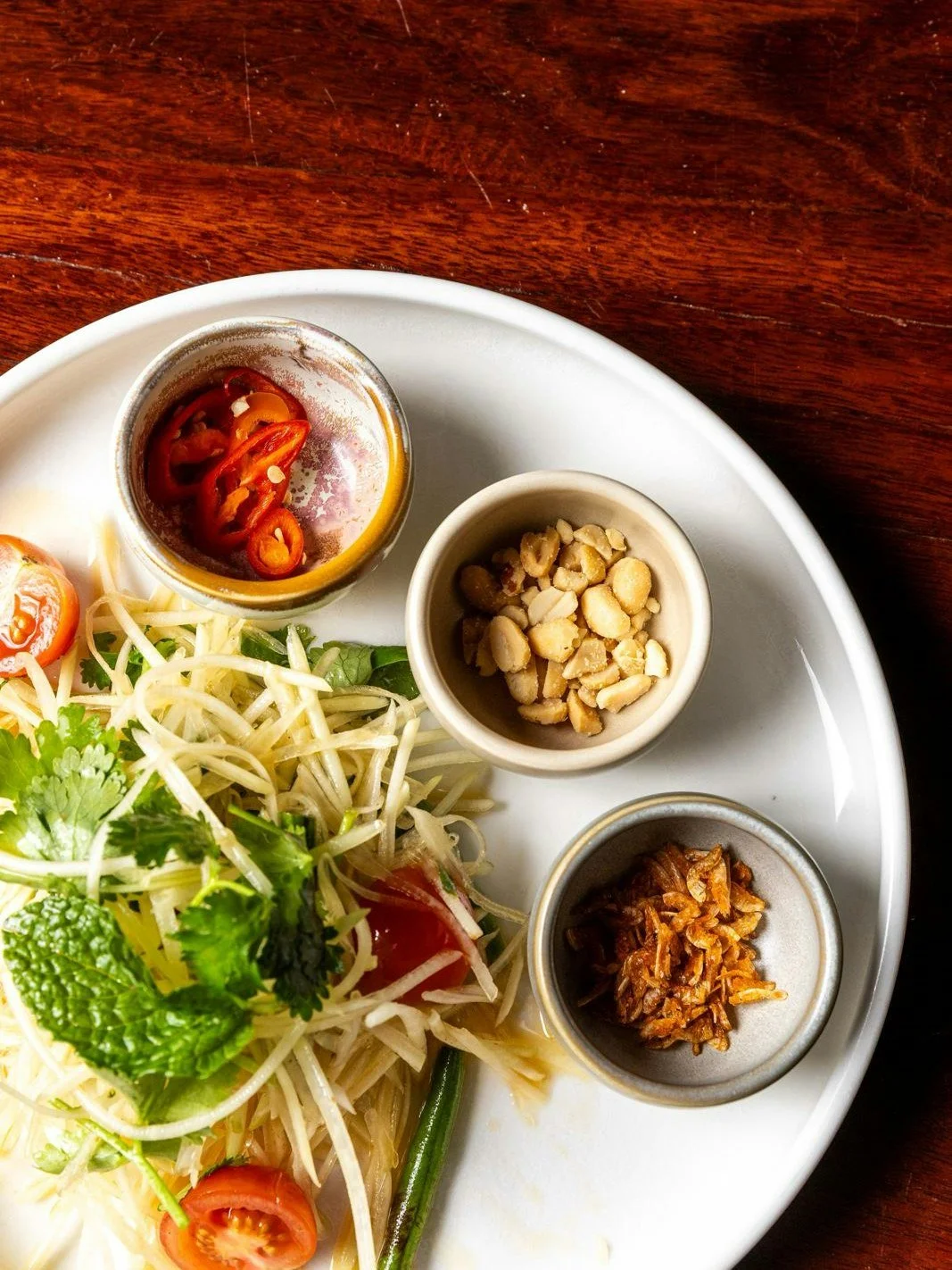 Fresh, fiery and impossible to ignore 🌶️

Shredded green papaya, tossed in tangy tamarind dressing, layered with chilli heat and finished with roasted peanut crunch ~ bright, bold and seriously addictive 🥢✨

#livelikelibertine

Call (07) 3367 3353 