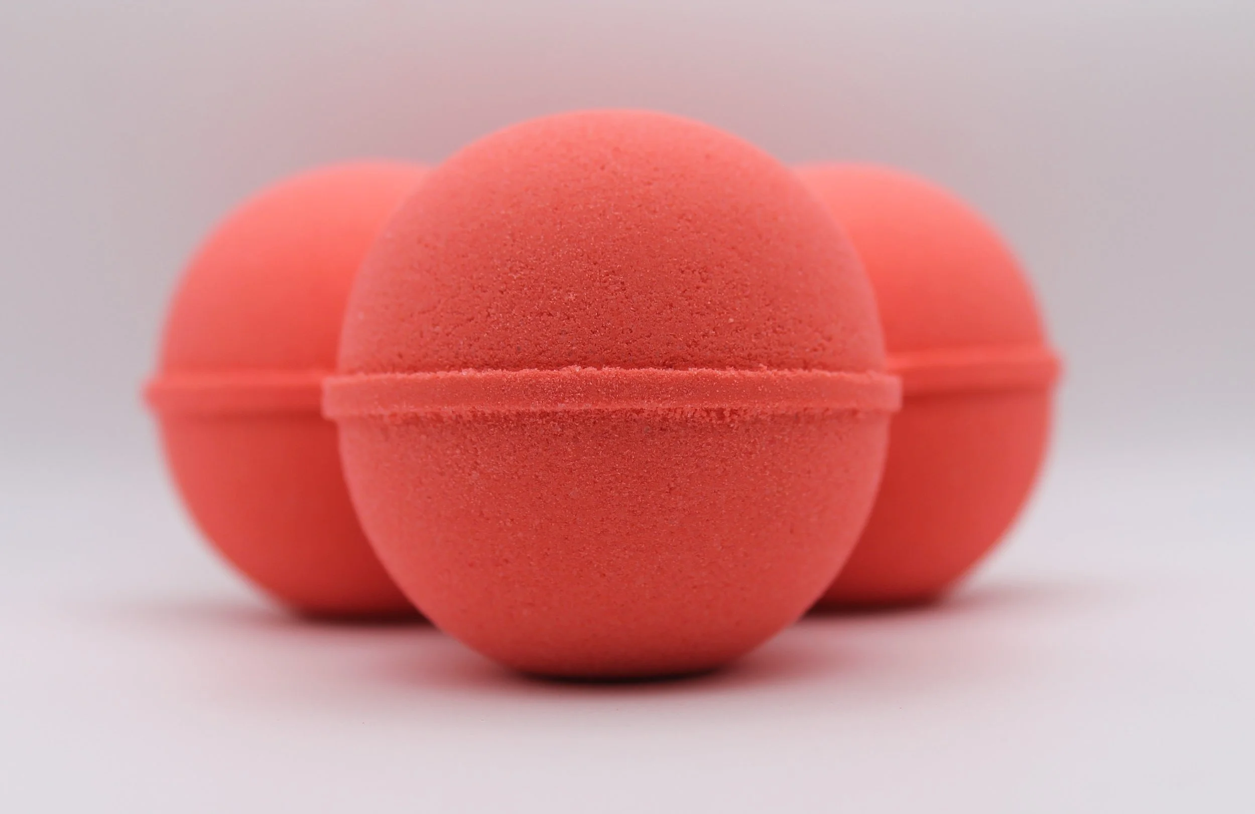 Sunday Mornings Bath Bomb with a nostalgic scent of citrus, mixed berries, and vanilla, evoking joyful childhood memories.