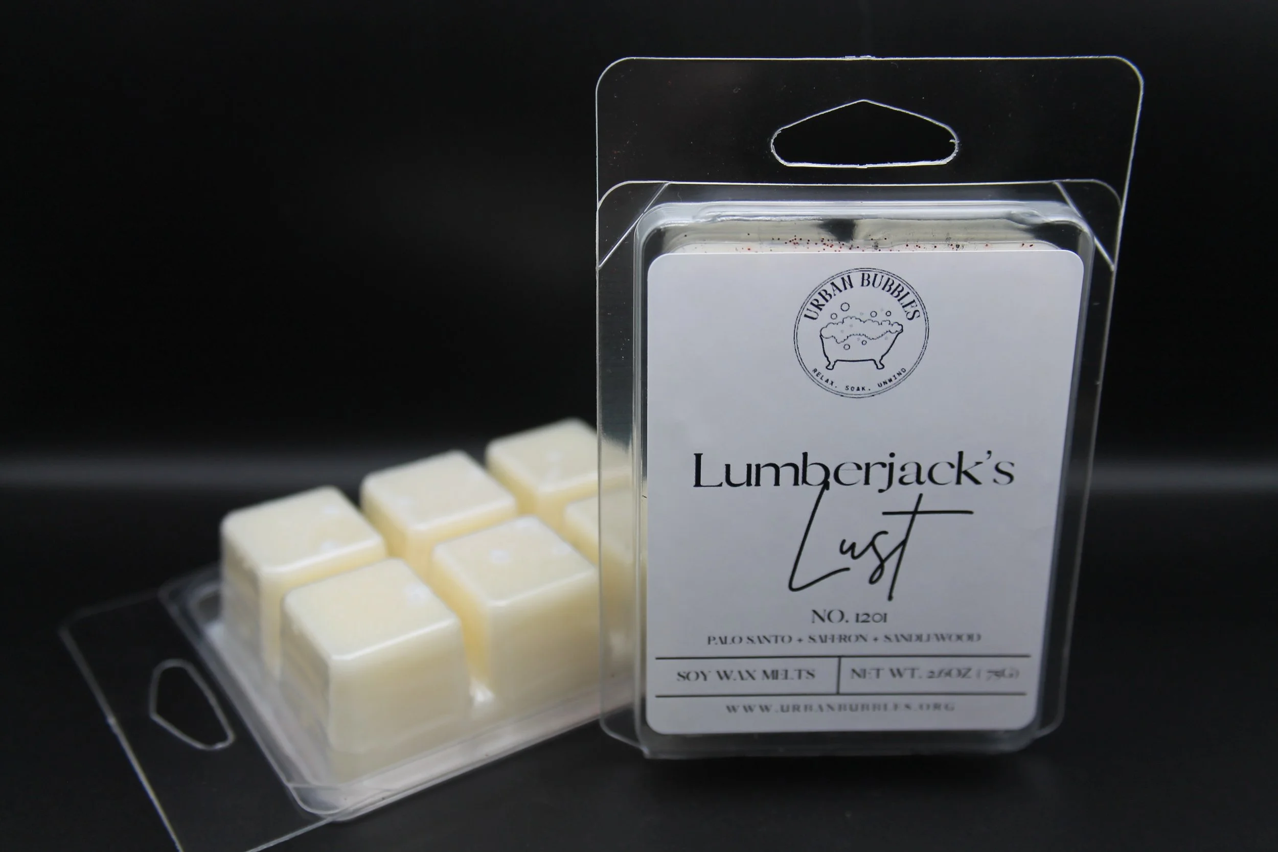 Lumberjack's Lust Wax Melt in earthy tones with a bold fragrance of citrus, clove, florals, spicy ginger, woods, amber, and musk, perfect for creating a cozy woodland ambiance.