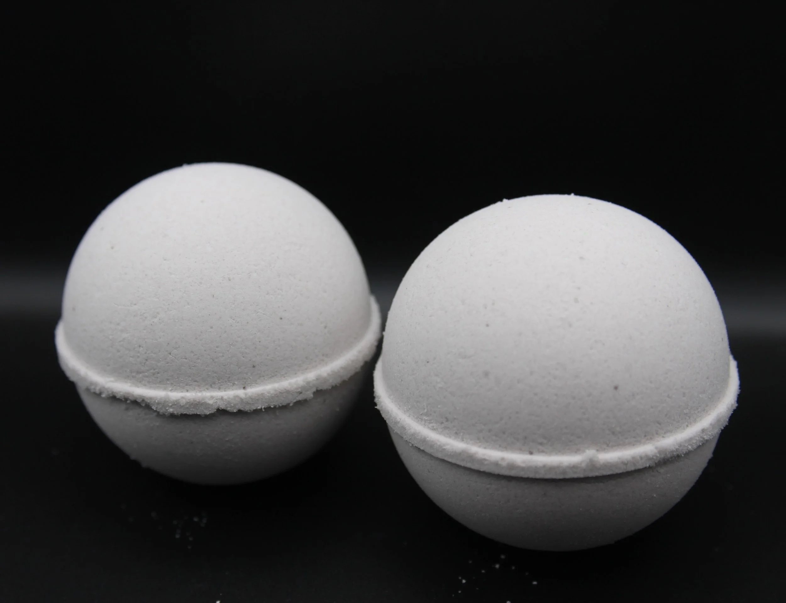 Cashmere After Dark Bath Bomb in light creamy gray tones with floral and musk scents, perfect for a sultry and indulgent bath experience.