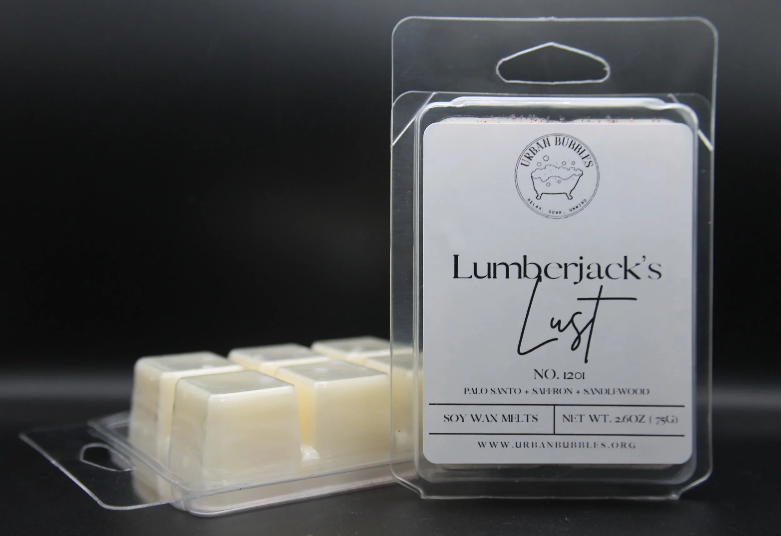 Lumberjack's Lust Wax Melt in earthy tones with a bold fragrance of citrus, clove, florals, spicy ginger, woods, amber, and musk, perfect for creating a cozy woodland ambiance.
