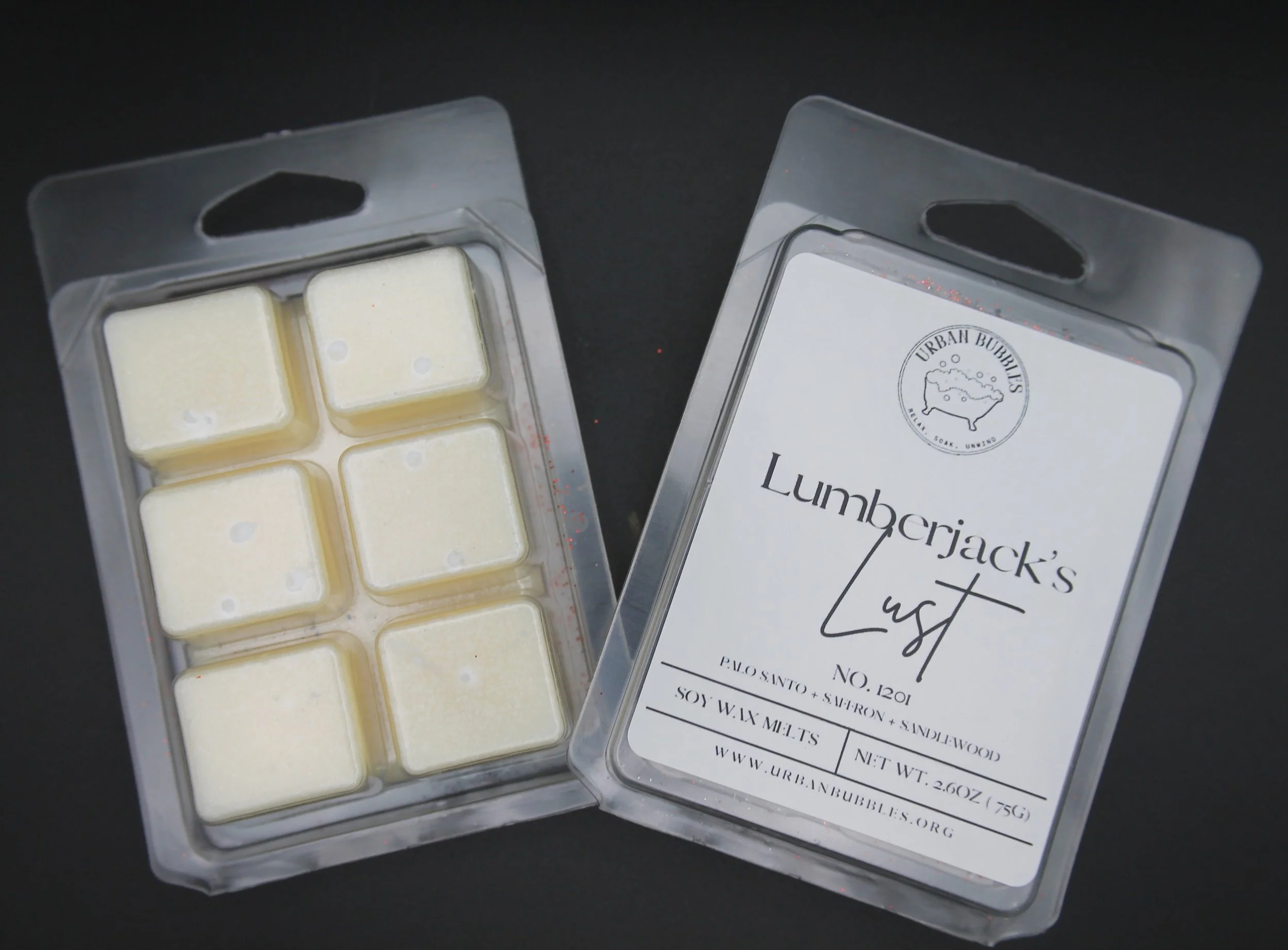 Lumberjack's Lust Wax Melt in earthy tones with a bold fragrance of citrus, clove, florals, spicy ginger, woods, amber, and musk, perfect for creating a cozy woodland ambiance.
