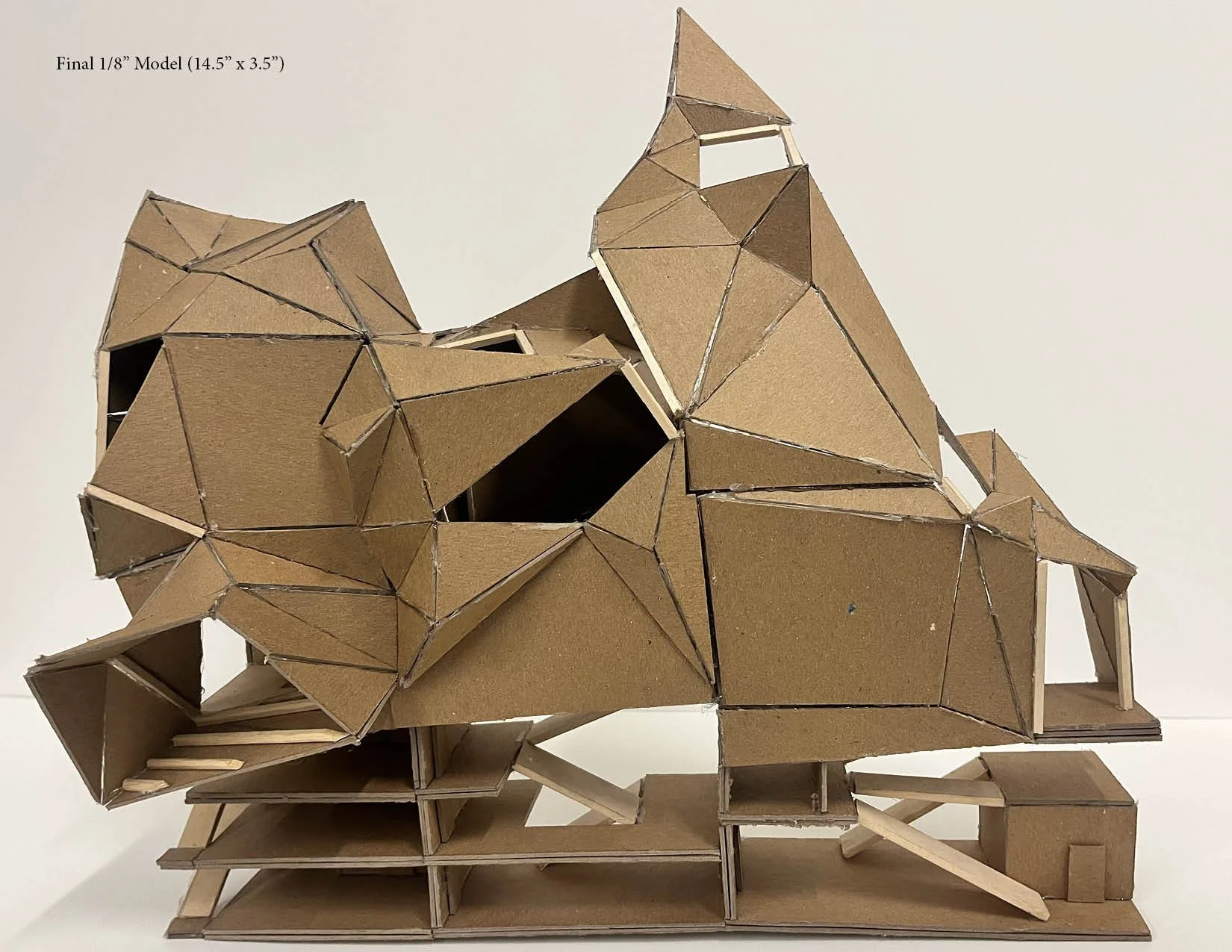 Architectural model made of cardboard and wooden sticks, featuring multiple interconnected geometric shapes and levels.
