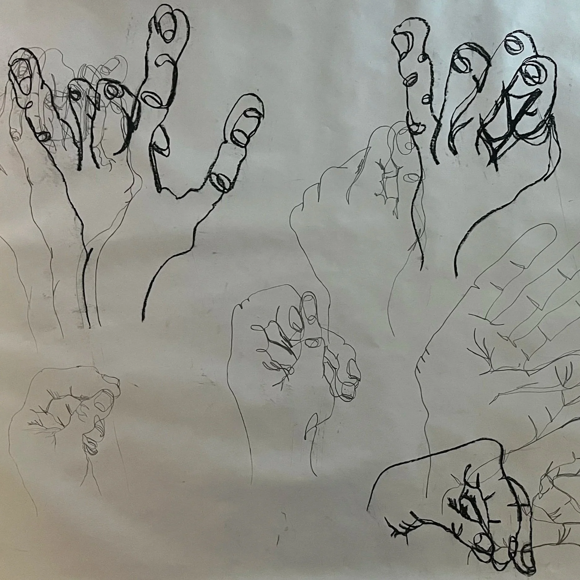 A collection of line art sketches of various hands in different positions on paper.