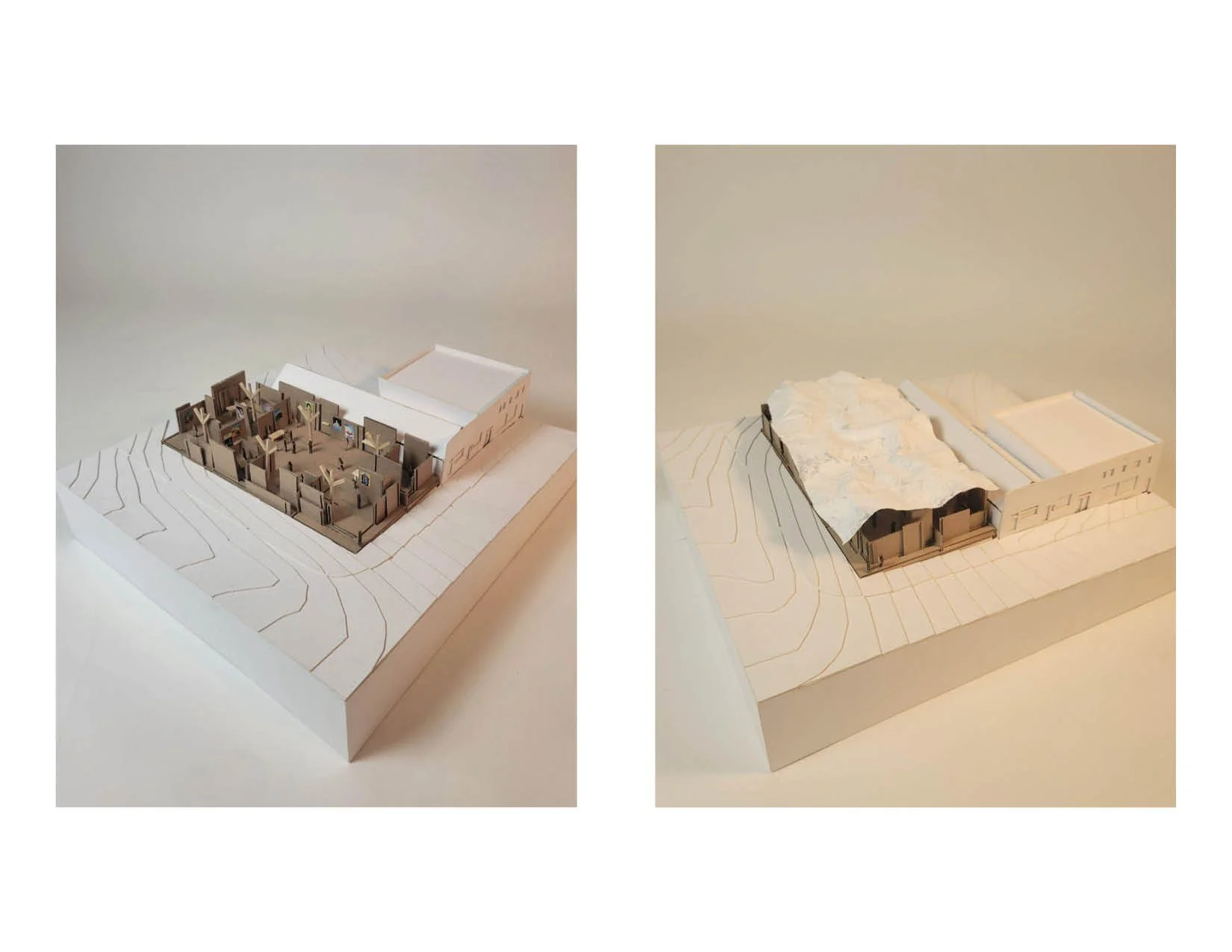 Architectural models of a building's interior and exterior with topographical landscape features on a white base.